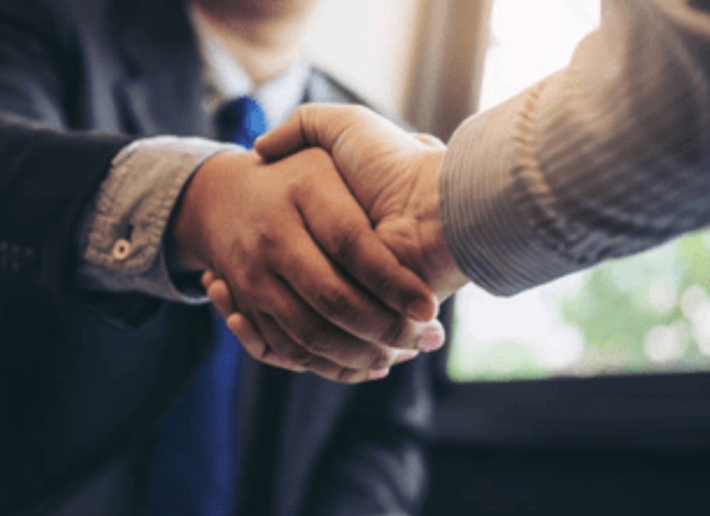A handshake sealing a partnership across the table