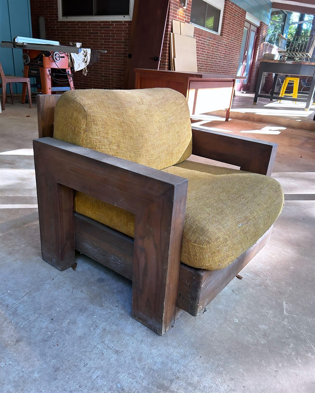 Blocky-arm mid-century lounge chair before restoration