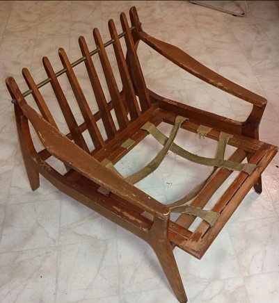 Sculpted-arm lounge chair stripped to a bare frame