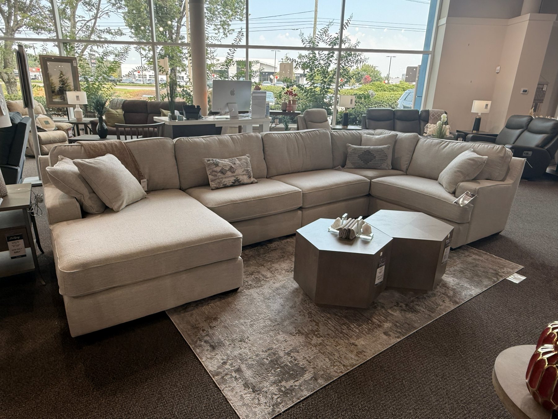 Neutral farmhouse-modern sectional anchoring the showroom floor