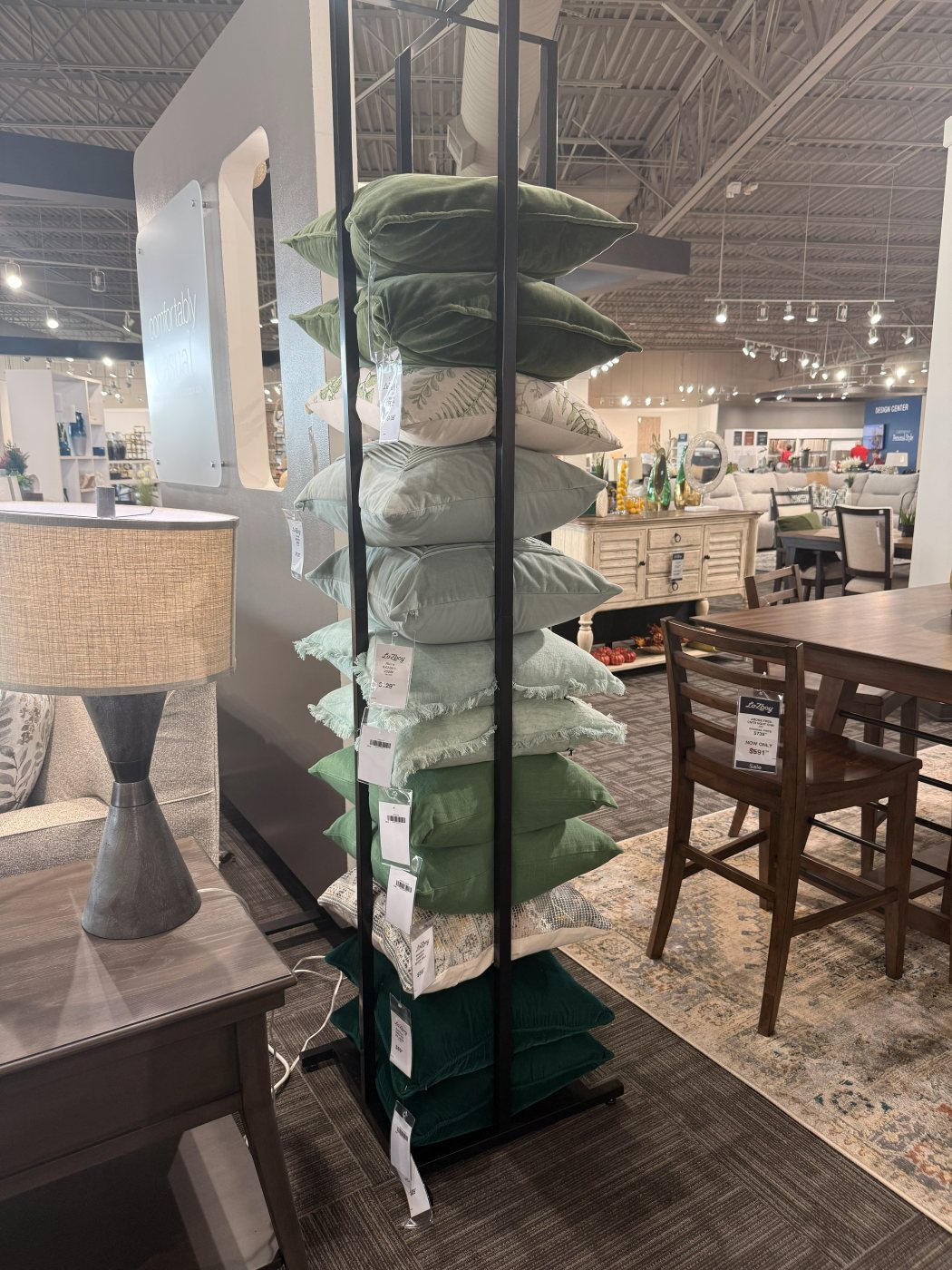 Rack of fern and sage green velvet throw pillows